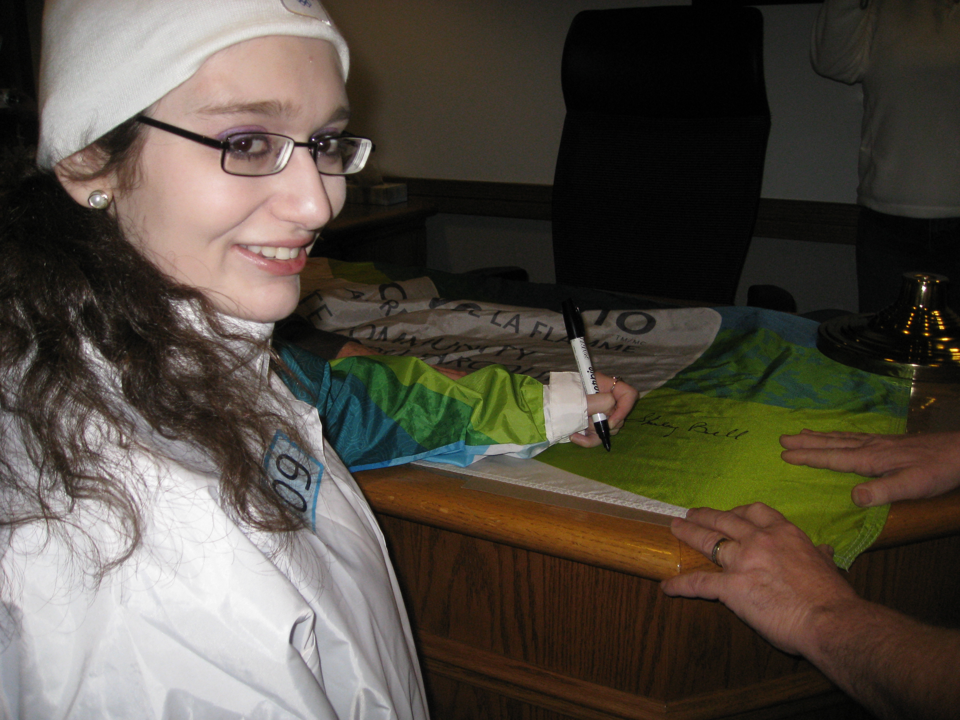 Paula signs the Olympic flag